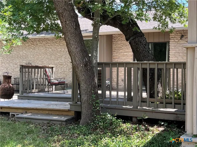 a view of house with a yard and potted plants
