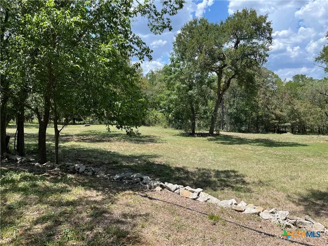 a view of outdoor space with trees all around