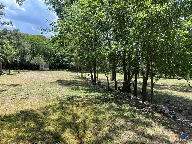 a view of outdoor space with trees all around