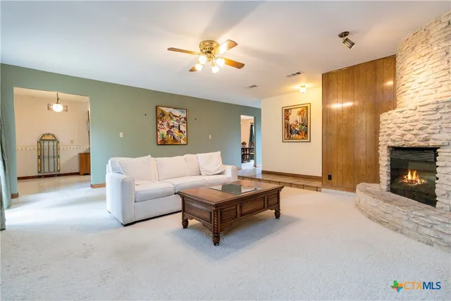 a living room with furniture and a fireplace