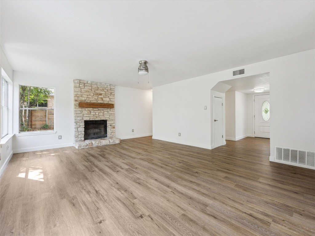 4525 Langtry Lane Austin, TX 78749 - Photo 12 of 31 a view of empty room with wooden floor and fireplace