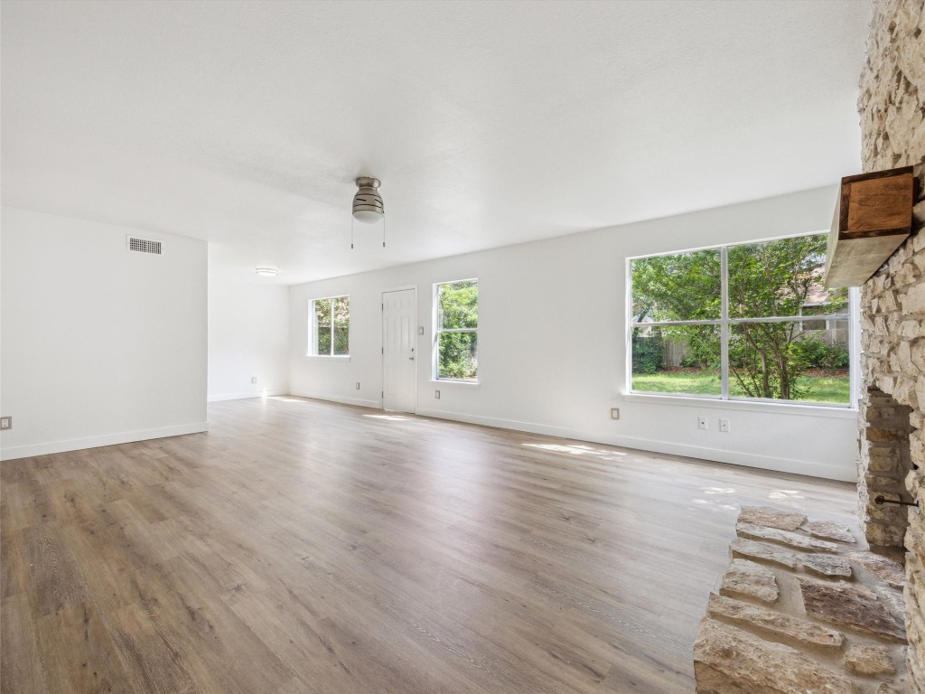 4525 Langtry Lane Austin, TX 78749 - Photo 13 of 31 an empty room with wooden floor and windows