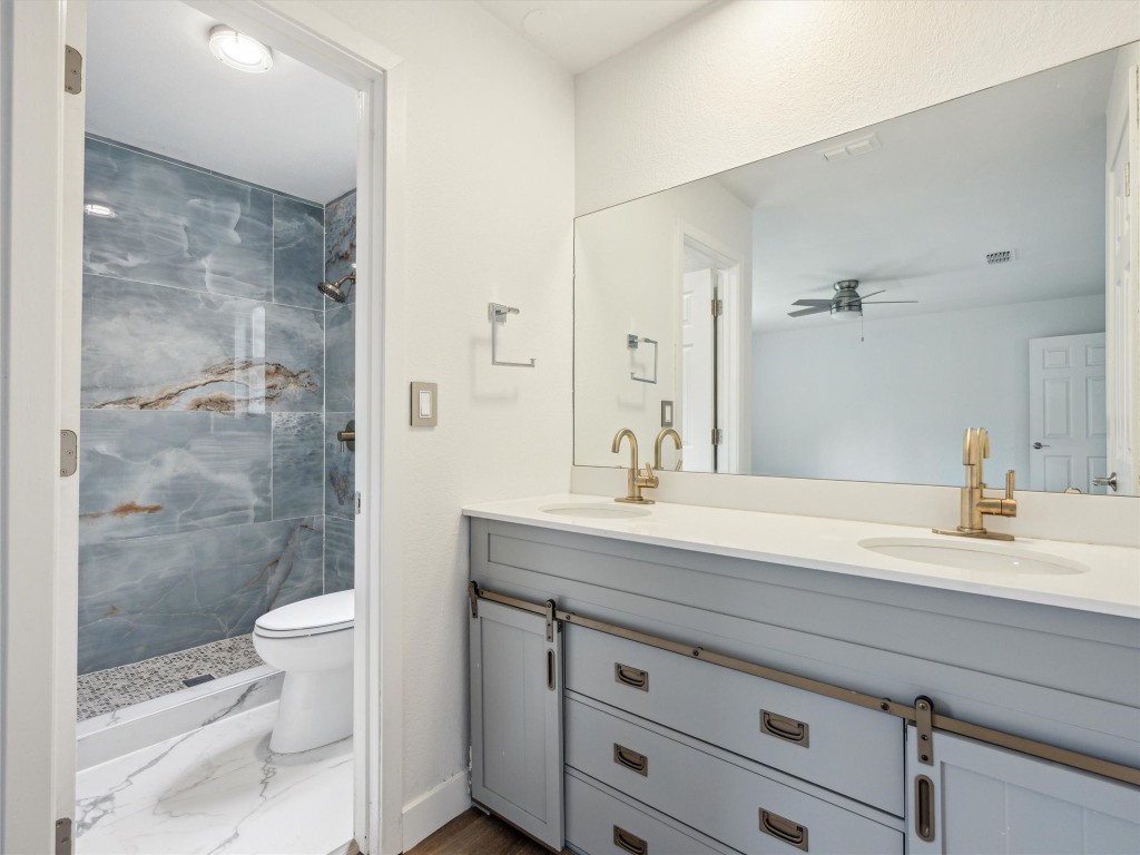4525 Langtry Lane Austin, TX 78749 - Photo 15 of 31 a bathroom with a sink a toilet and shower