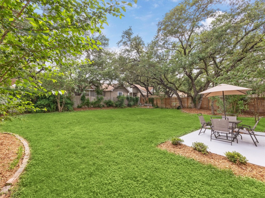 4525 Langtry Lane Austin, TX 78749 - Photo 27 of 31 a view of a garden with lawn chairs under an umbrella