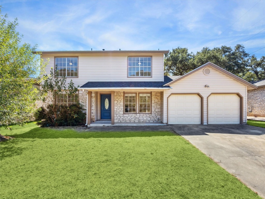 4525 Langtry Lane Austin, TX 78749 - Photo 5 of 31 a front view of a house with a yard and garage