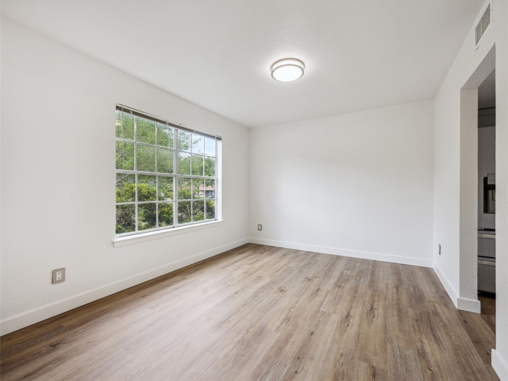 4525 Langtry Lane Austin, TX 78749 - Photo 7 of 31 an empty room with wooden floor and windows