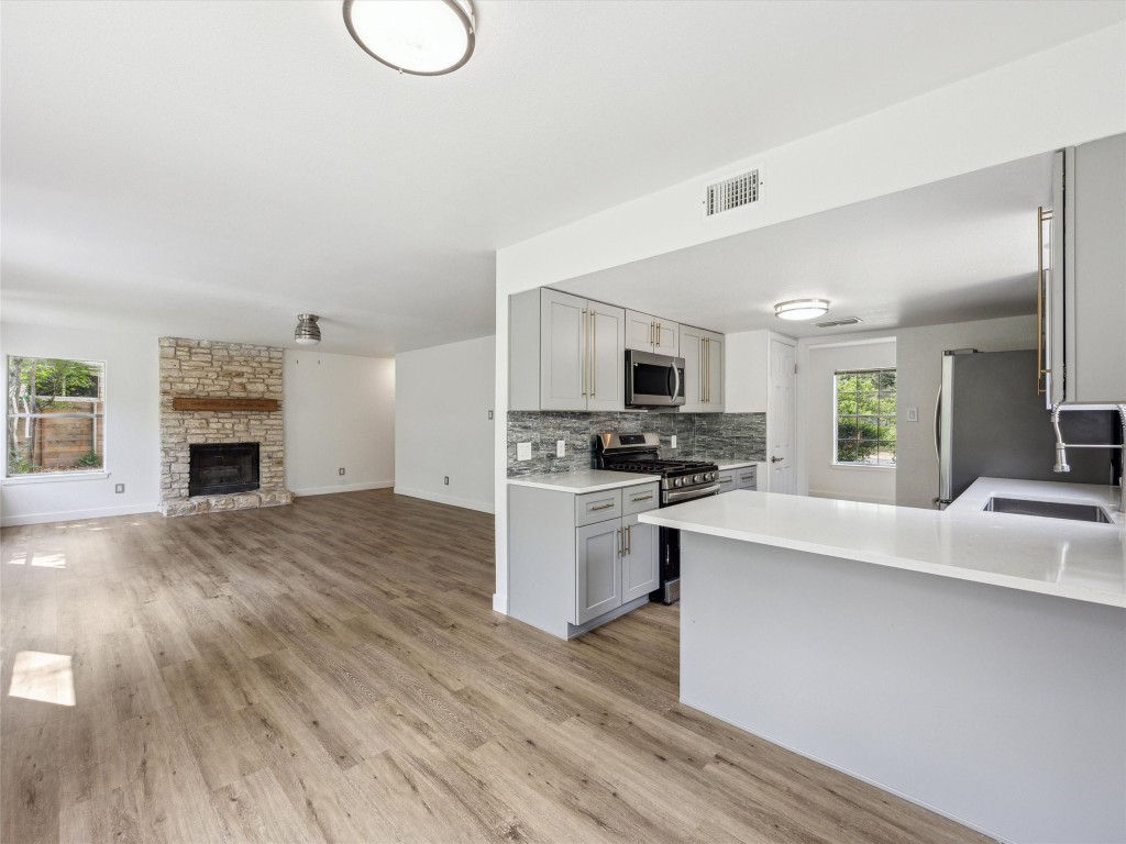 4525 Langtry Lane Austin, TX 78749 - Photo 8 of 31 a kitchen with granite countertop a stove top oven sink and cabinets