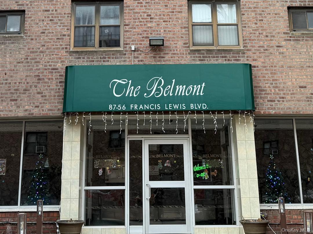 87-56 Francis Lewis Boulevard, Unit A52 Queens, NY 11427 - Photo 3 of 10 a front view of a building with glass windows