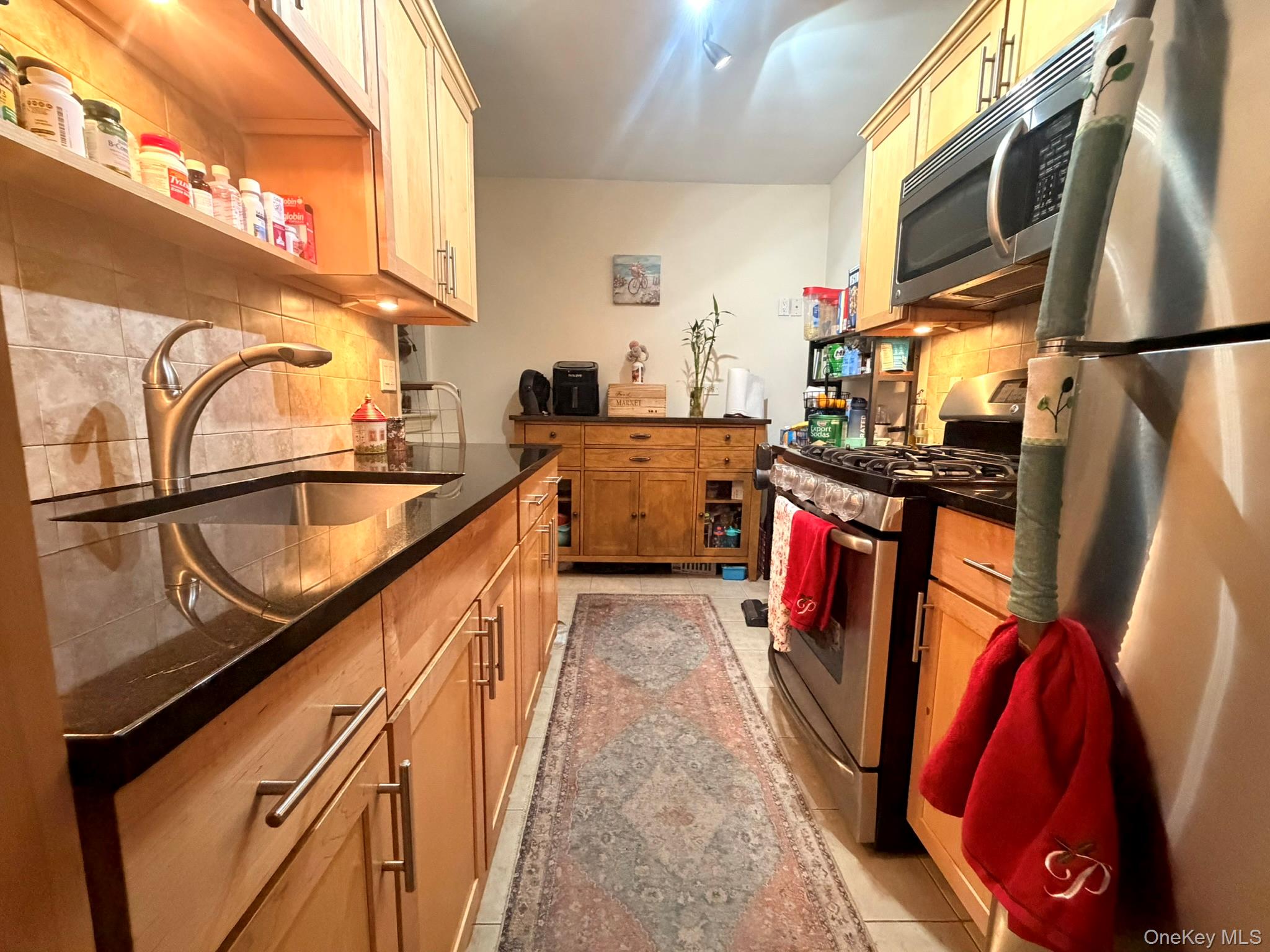 87-56 Francis Lewis Boulevard, Unit A52 Queens, NY 11427 - Photo 4 of 10 a view of a kitchen with fridge and wooden floor