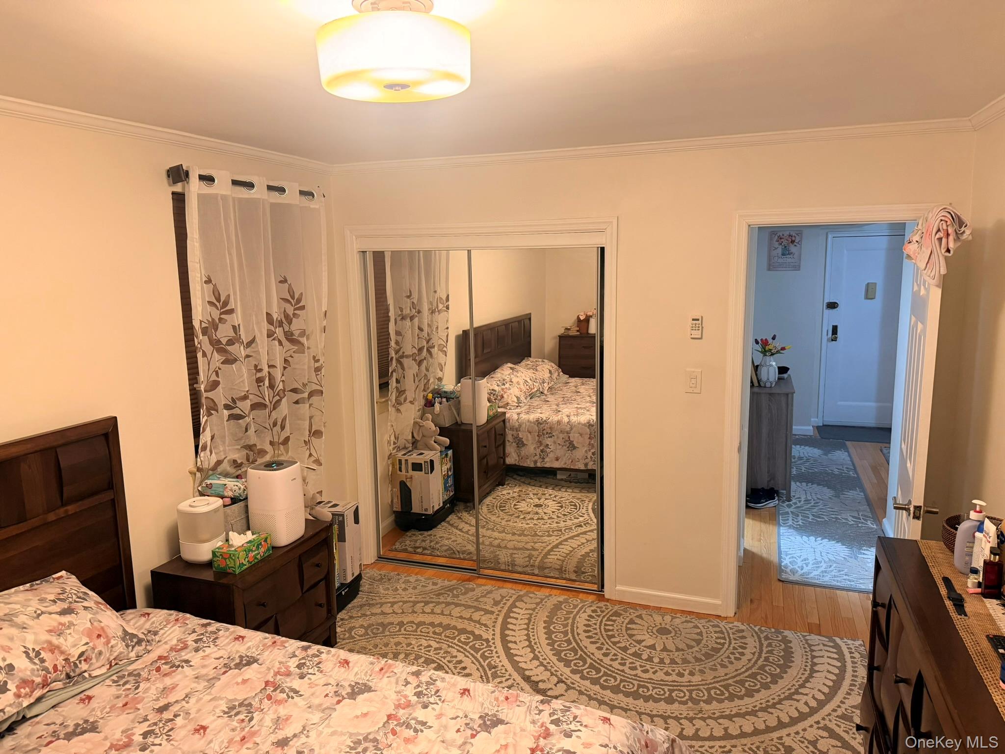 87-56 Francis Lewis Boulevard, Unit A52 Queens, NY 11427 - Photo 6 of 10 a bedroom with a bed and wooden floor