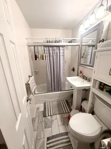 a white toilet sitting next to a bathroom sink