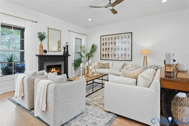 a living room with furniture a large window and a fireplace