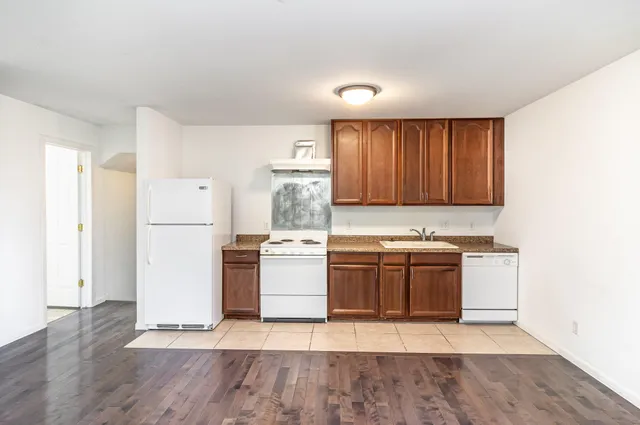 a view of a kitchen with wooden floor