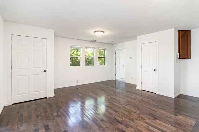 a view of a kitchen with a sink and refrigerator