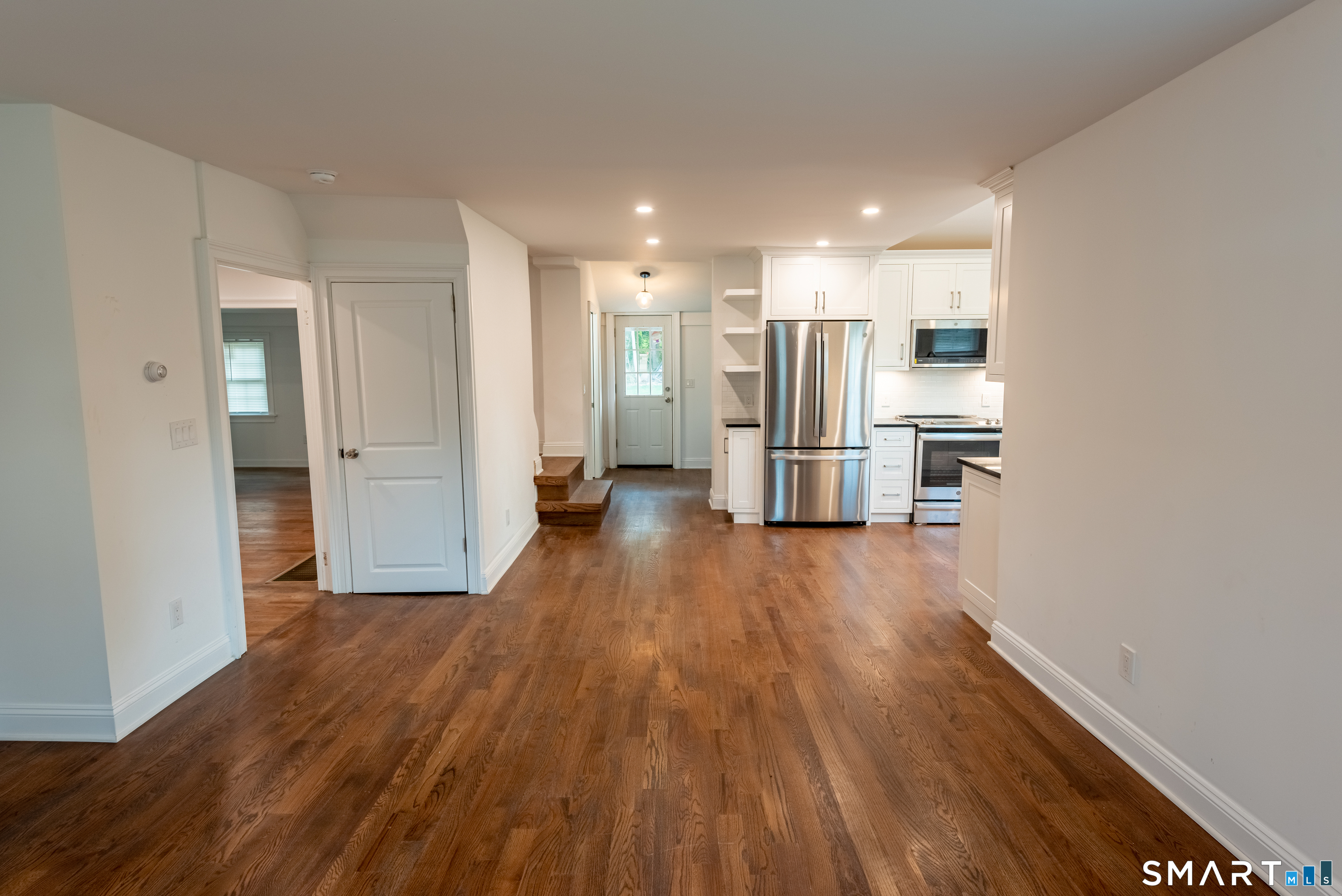 Open main level with hardwood floors throughout