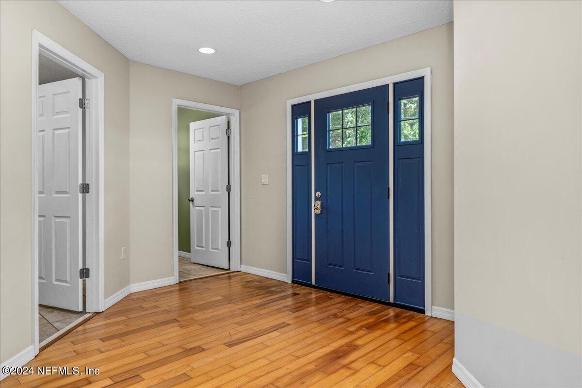 260 Brickyard Road Middleburg, FL 32068 - Photo 13 of 52 a view of an empty room with window and wooden floor