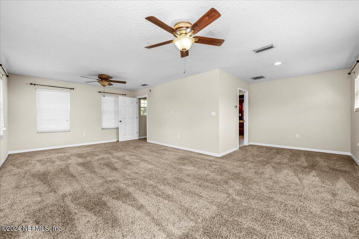 260 Brickyard Road Middleburg, FL 32068 - Photo 32 of 52 an empty room with ceiling fan and window