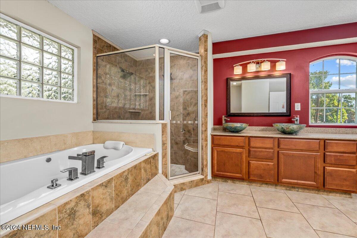 260 Brickyard Road Middleburg, FL 32068 - Photo 34 of 52 a bathroom with a tub sink and mirror