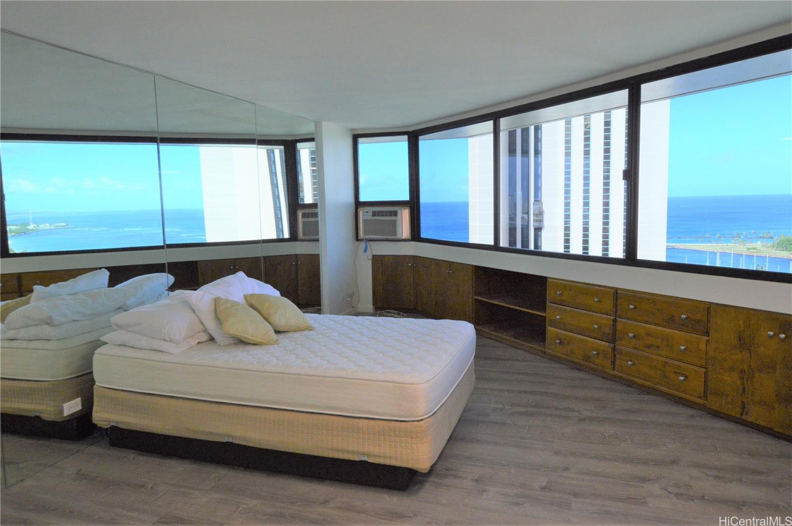 a bedroom with a large bed and a large window
