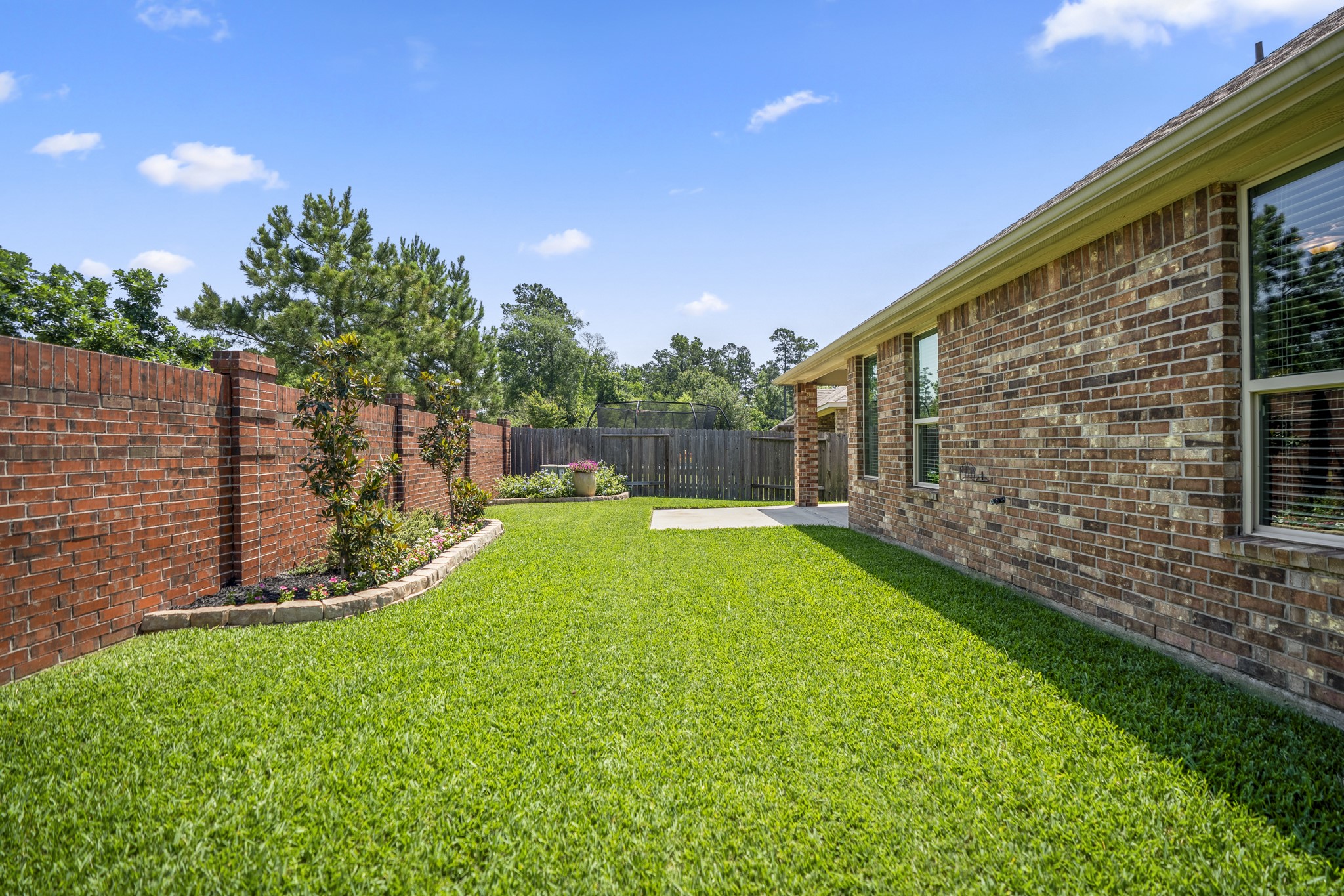 5522 Glenfield Spring Lane Spring, TX 77389 - Photo 36 of 46 The brick exterior of the house complements the outdoor space, offering a serene and private setting.