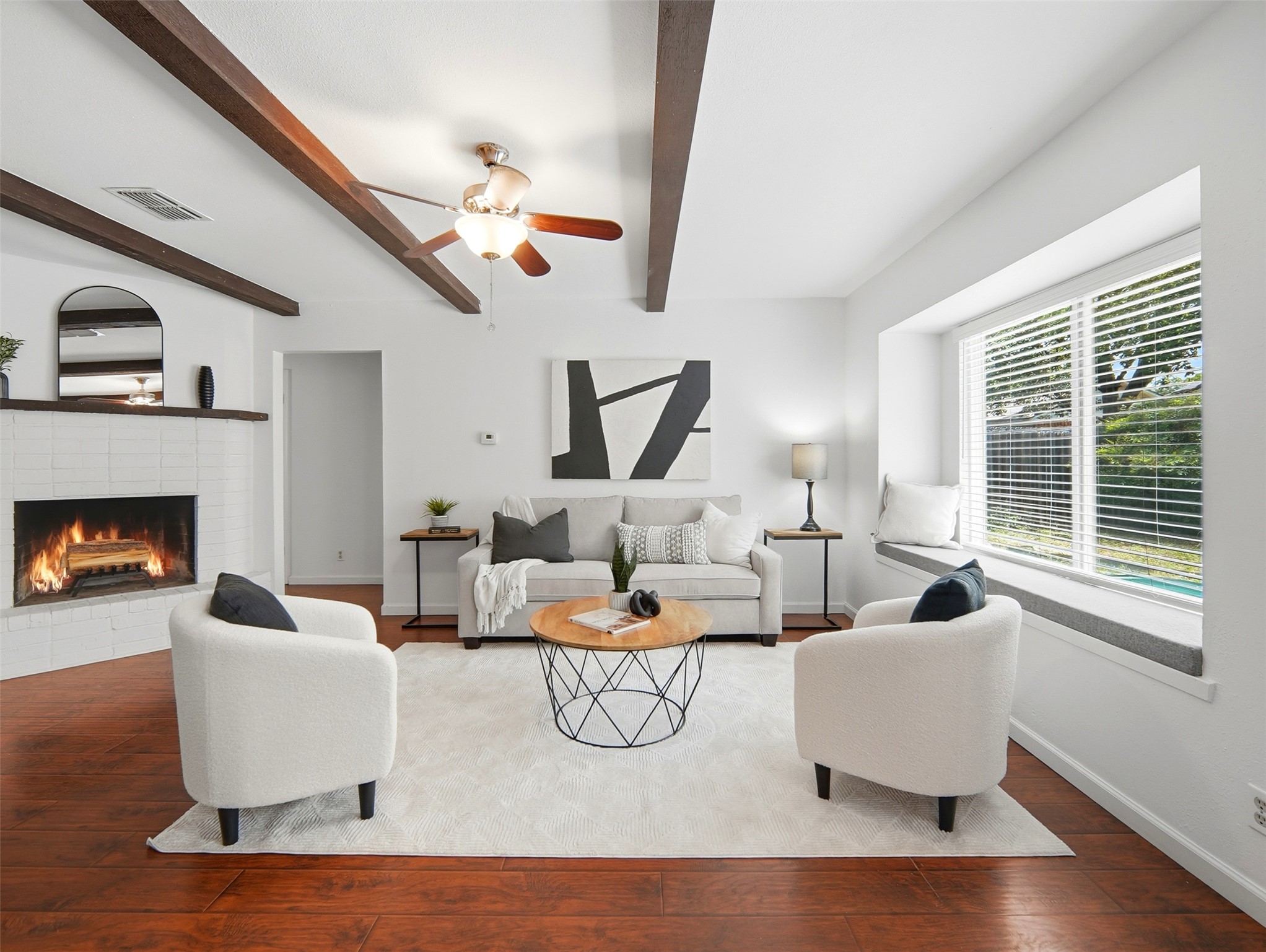 7001 Windrift Way Austin, TX 78745 - Photo 2 of 17 Exposed wood beams and a cozy fireplace define this inviting living space.
