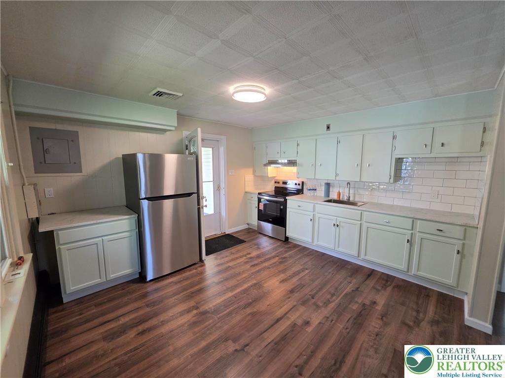 218 Lehigh Street Walnutport, PA 18088 - Photo 8 of 22 a kitchen with a refrigerator a sink and cabinets
