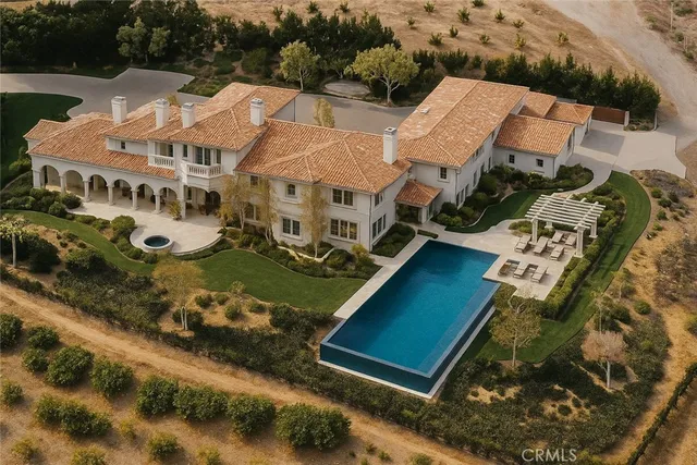 an aerial view of multiple houses with a yard