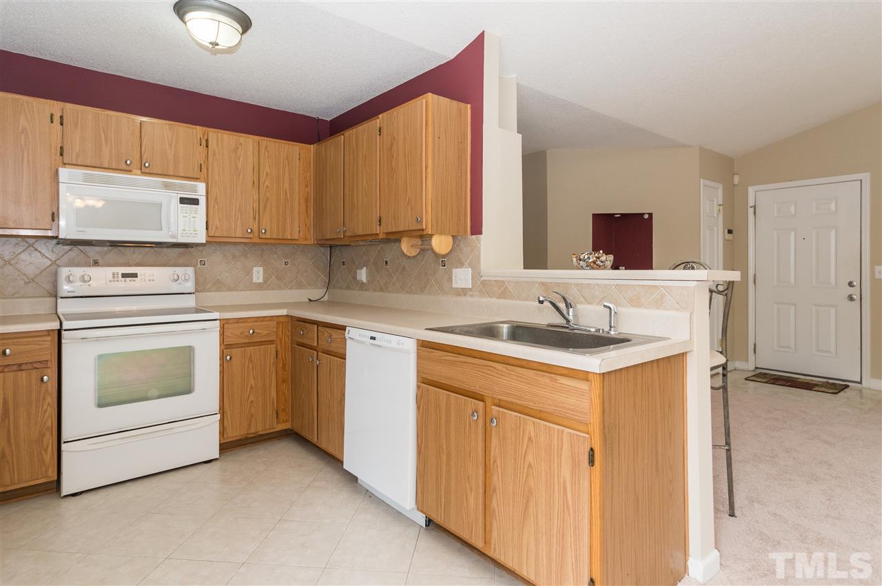 5008 Silverdene Street Raleigh, NC 27616 - Photo 6 of 23 a kitchen with a sink stove and cabinets