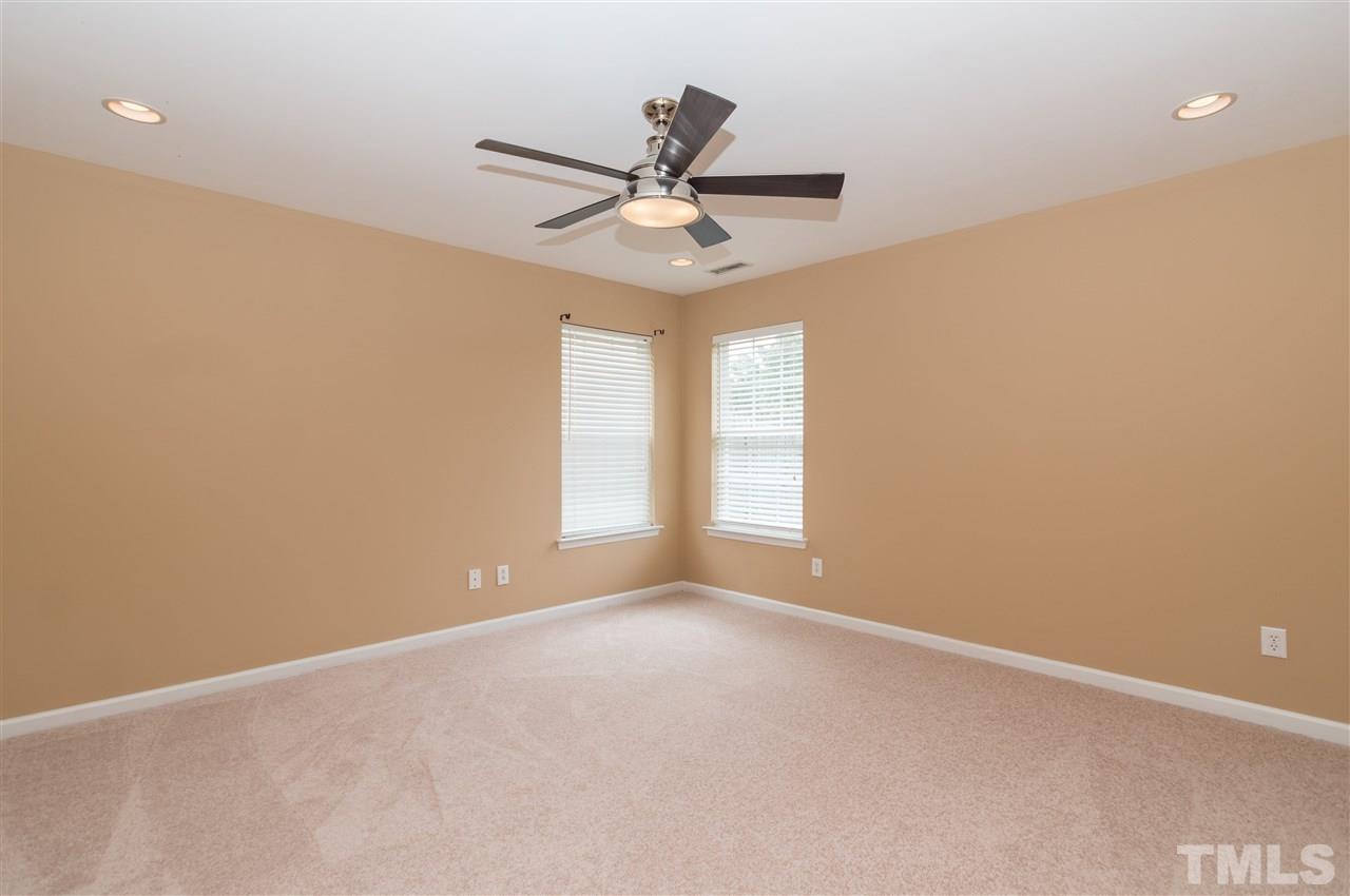 5008 Silverdene Street Raleigh, NC 27616 - Photo 10 of 23 an empty room with windows and fan