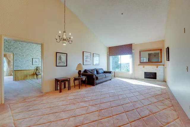 a living room with fireplace furniture and a chandelier