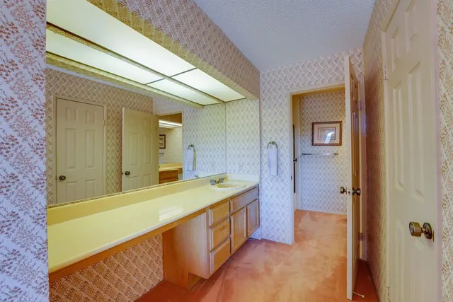 a bathroom with a tub a sink and a mirror