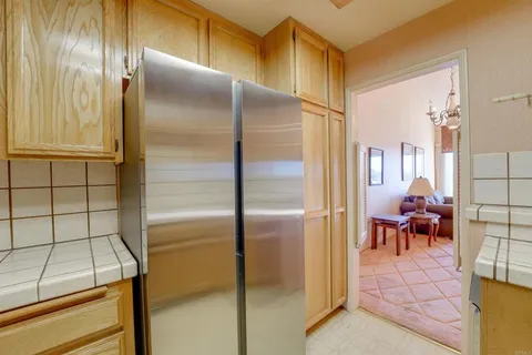 a kitchen with a refrigerator and table
