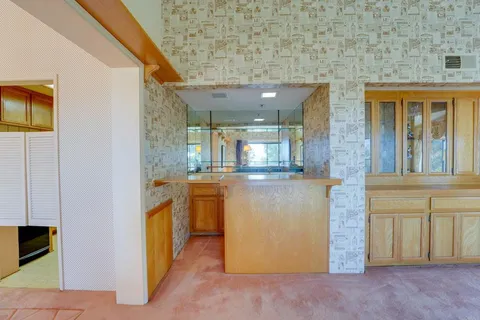 a view of kitchen with granite countertop cabinets