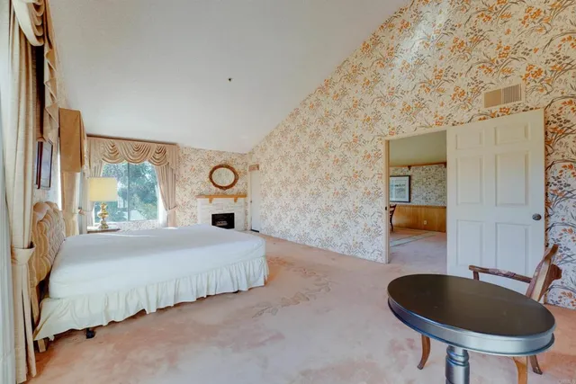 a bedroom with bed and a chair