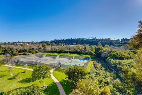 an aerial view of a residential houses with outdoor space and swimming pool