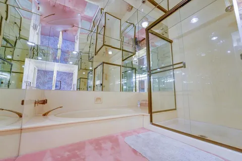 a bathroom with a bathtub and shower