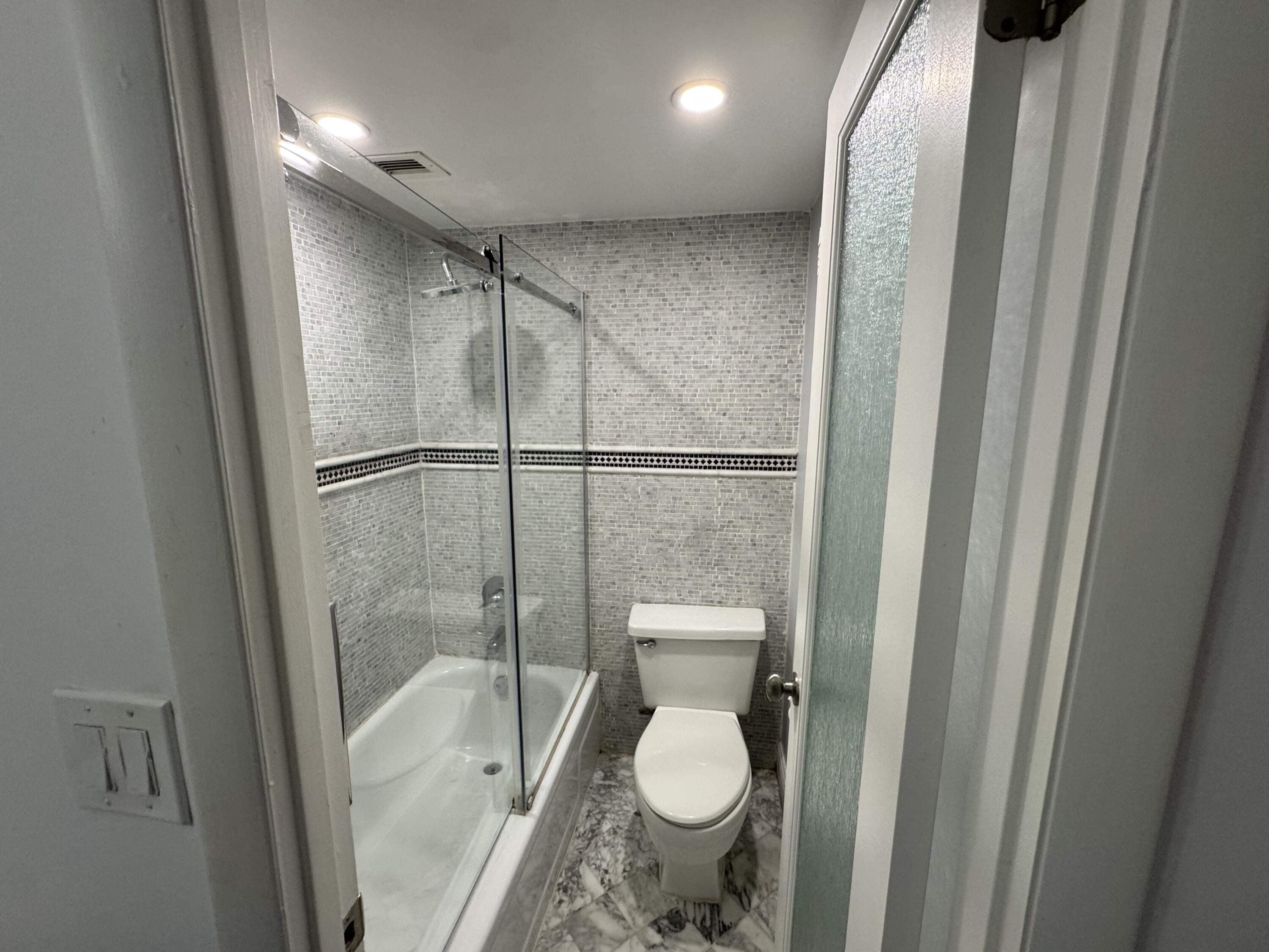 3540 South Ocean Boulevard, Unit 608 South Palm Beach, FL 33480 - Photo 11 of 35 a bathroom with a toilet and a shower