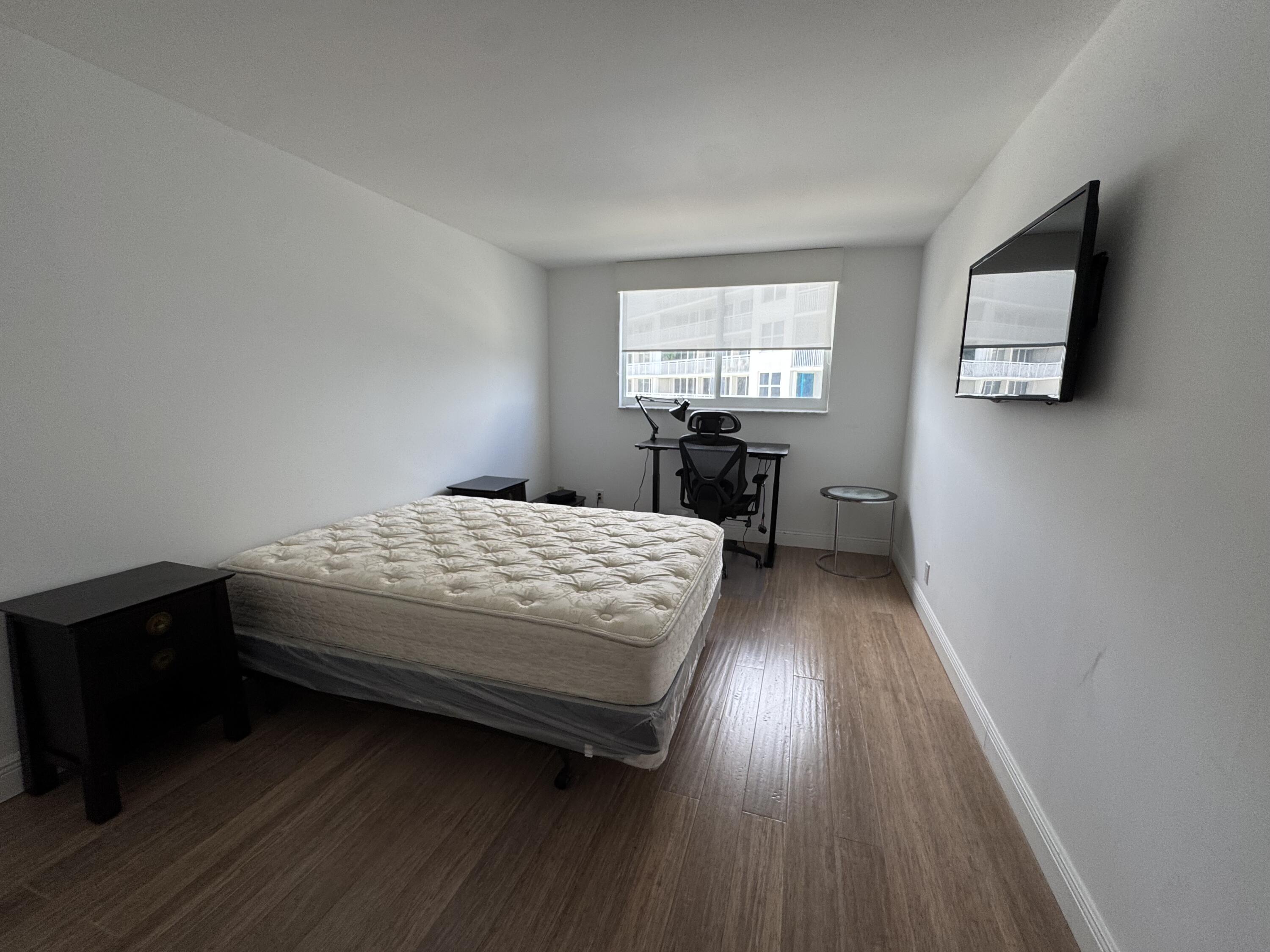 3540 South Ocean Boulevard, Unit 608 South Palm Beach, FL 33480 - Photo 12 of 35 a bedroom with a bed and a window