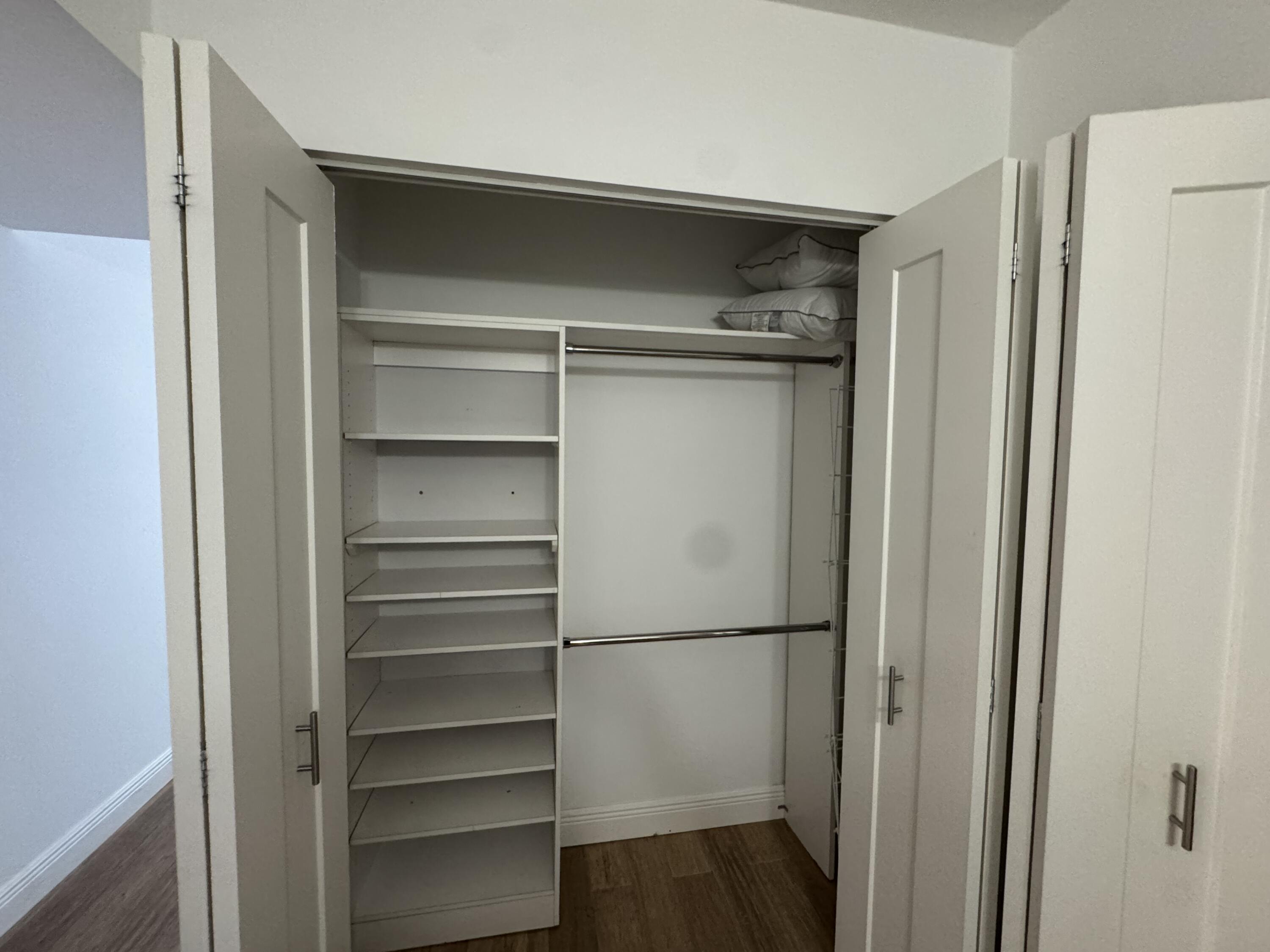 3540 South Ocean Boulevard, Unit 608 South Palm Beach, FL 33480 - Photo 15 of 35 a walk in closet with wooden floor