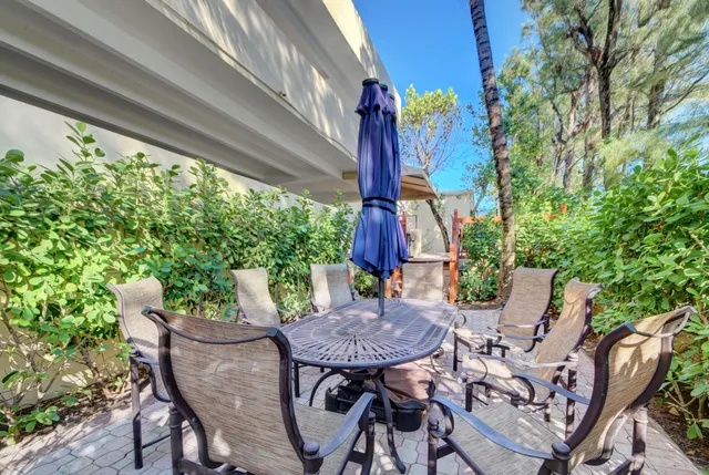 a view of a patio with table and chairs and potted plants