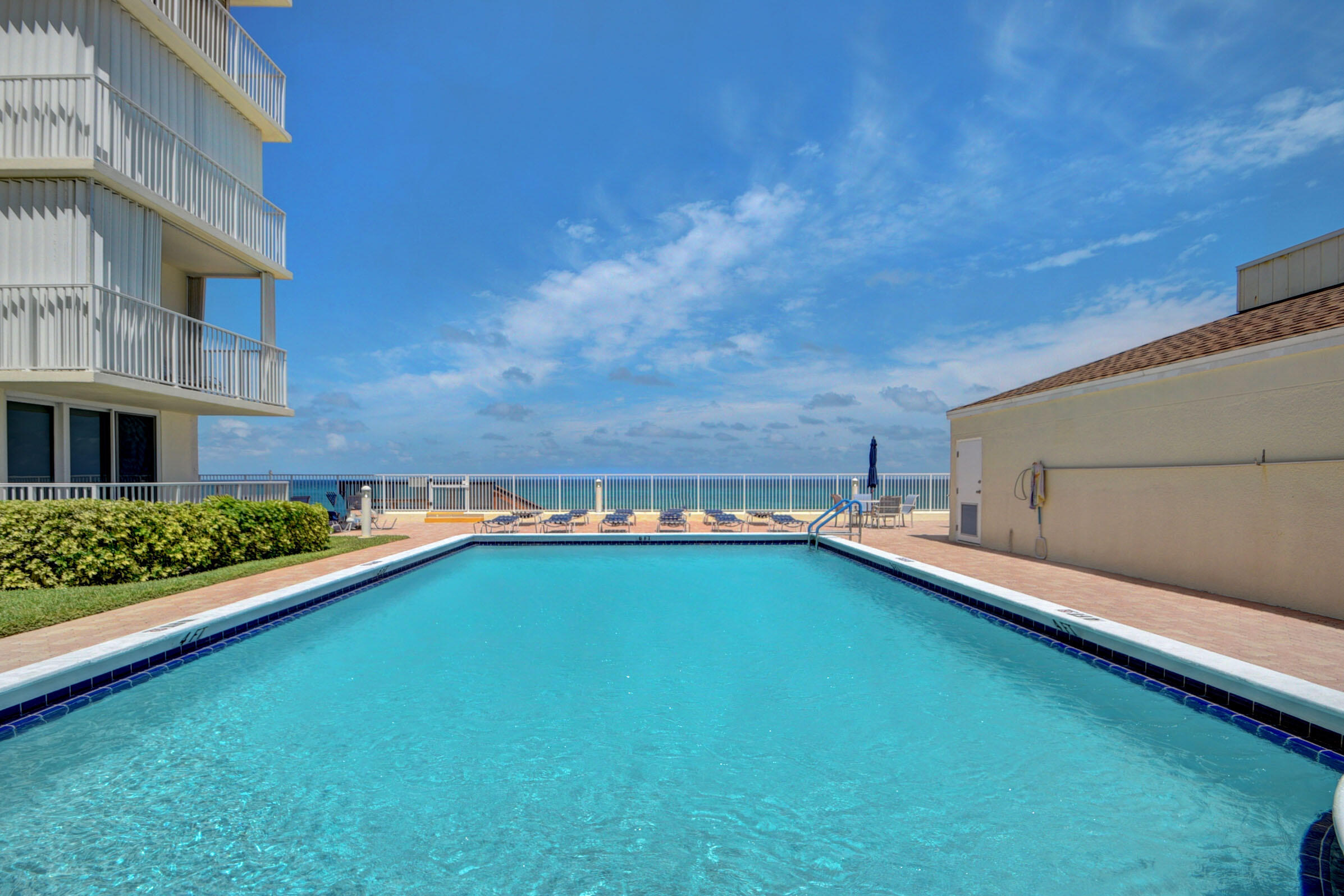 3540 South Ocean Boulevard, Unit 608 South Palm Beach, FL 33480 - Photo 33 of 35 a view of a swimming pool with an outdoor seating