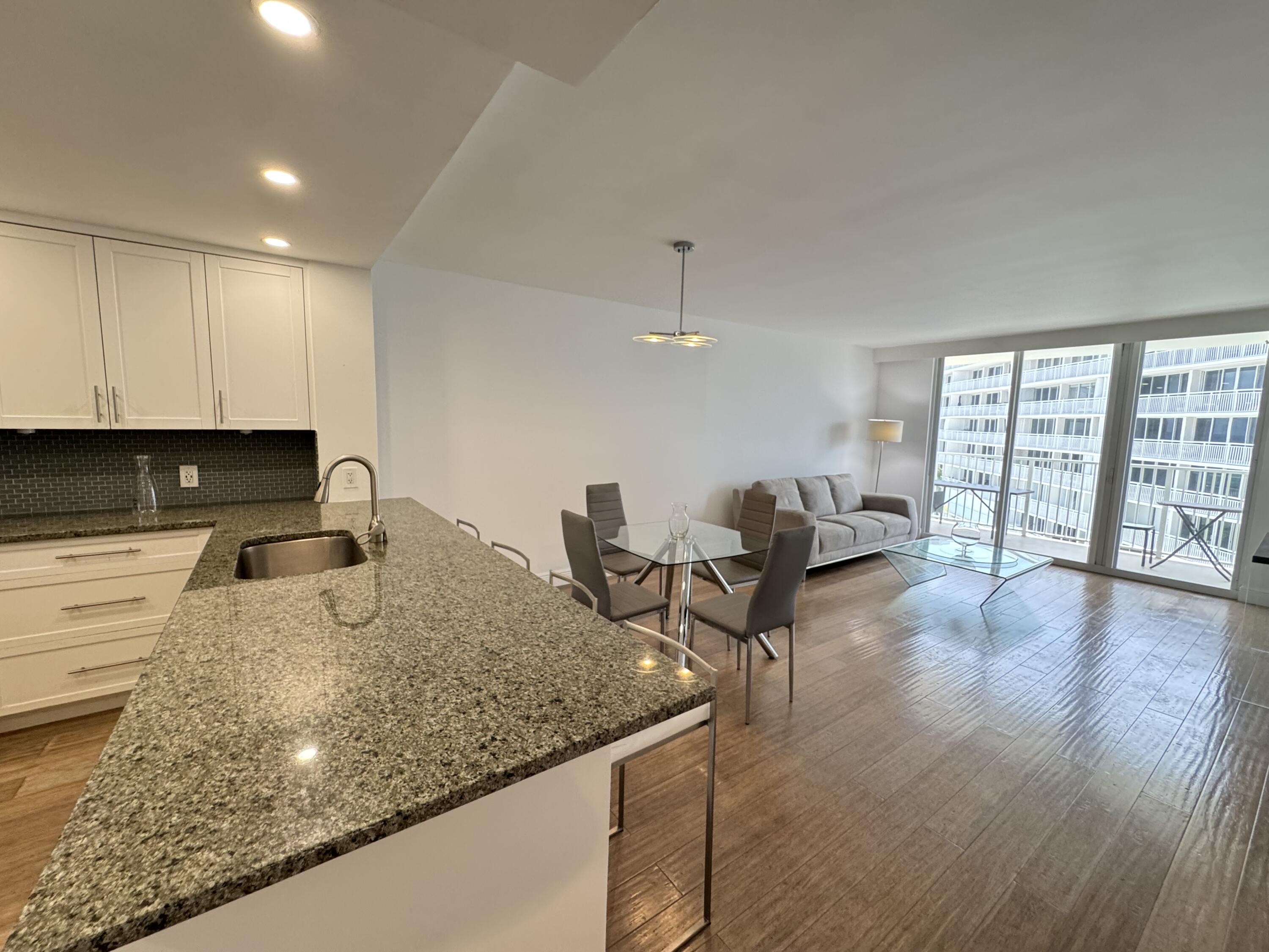 3540 South Ocean Boulevard, Unit 608 South Palm Beach, FL 33480 - Photo 4 of 35 a living room with furniture and a table