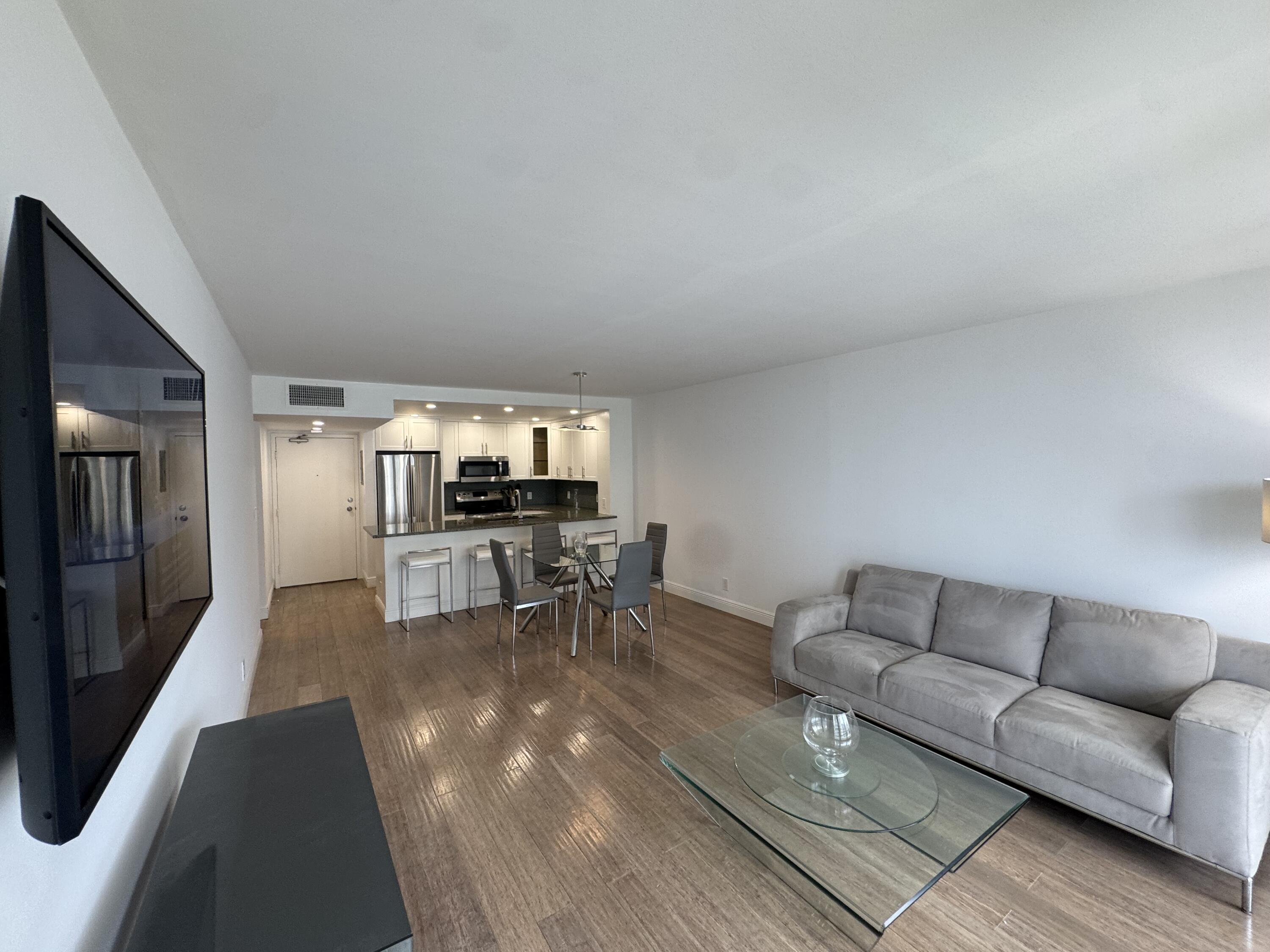 3540 South Ocean Boulevard, Unit 608 South Palm Beach, FL 33480 - Photo 8 of 35 a living room with furniture and a flat screen tv