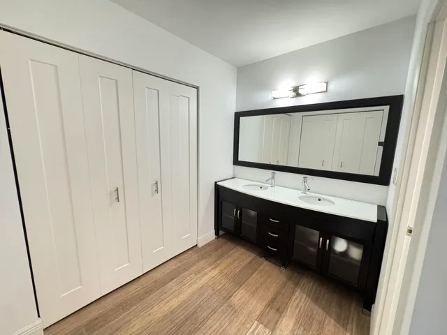 a bathroom with a double vanity sink and mirror