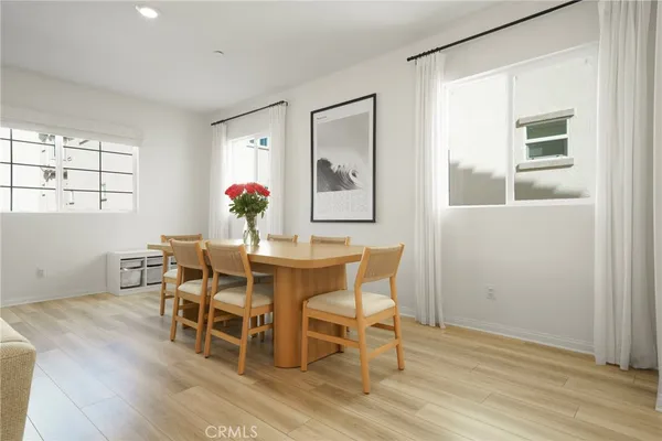 a kitchen with a sink cabinets stainless steel appliances with wooden floor and cabinets