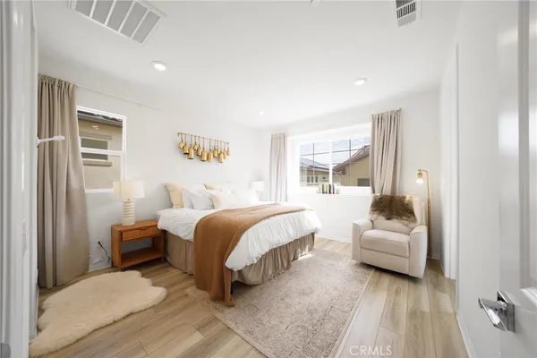 a bedroom with a bed and a large window