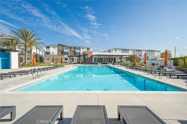 a view of swimming pool with outdoor seating and plants