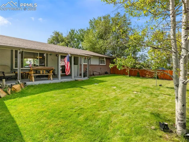 a view of a house with a backyard