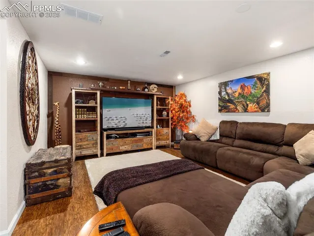 a view of patio with table and chairs and potted plants