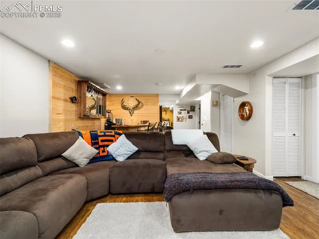 a view of a patio with table and chairs under an umbrella with a small yard